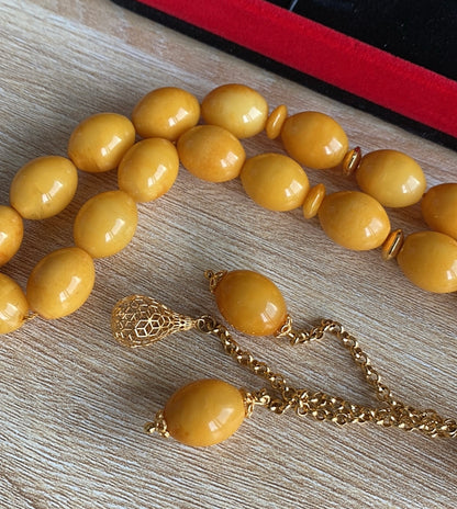 قطعة واحدة سبحة كهرب  ألماني  كبس، حجر كهرب خام طبيعي ١٠٠ بال ١٠٠ من دون اية مواد مضافه - الذهب اللي بالسبحة خام عيار 21 (S Gold)