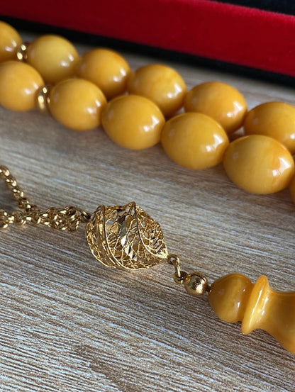 قطعة واحدة سبحة كهرب  ألماني  كبس، حجر كهرب خام طبيعي ١٠٠ بال ١٠٠ من دون اية مواد مضافه - الذهب اللي بالسبحة خام عيار 21 (S Gold)